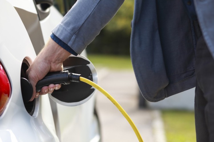 main homme branche prise voiture electrique